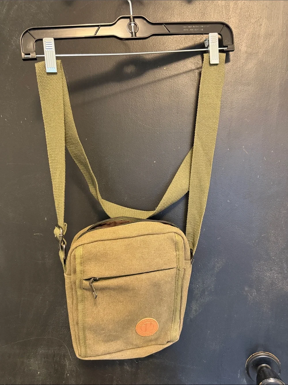 Unisex crossbody Nupouch crossbody bag. Olive colored with tan accent patch.
